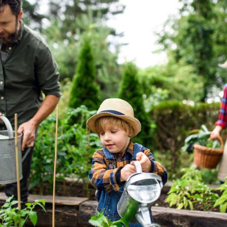 Kid watering garden